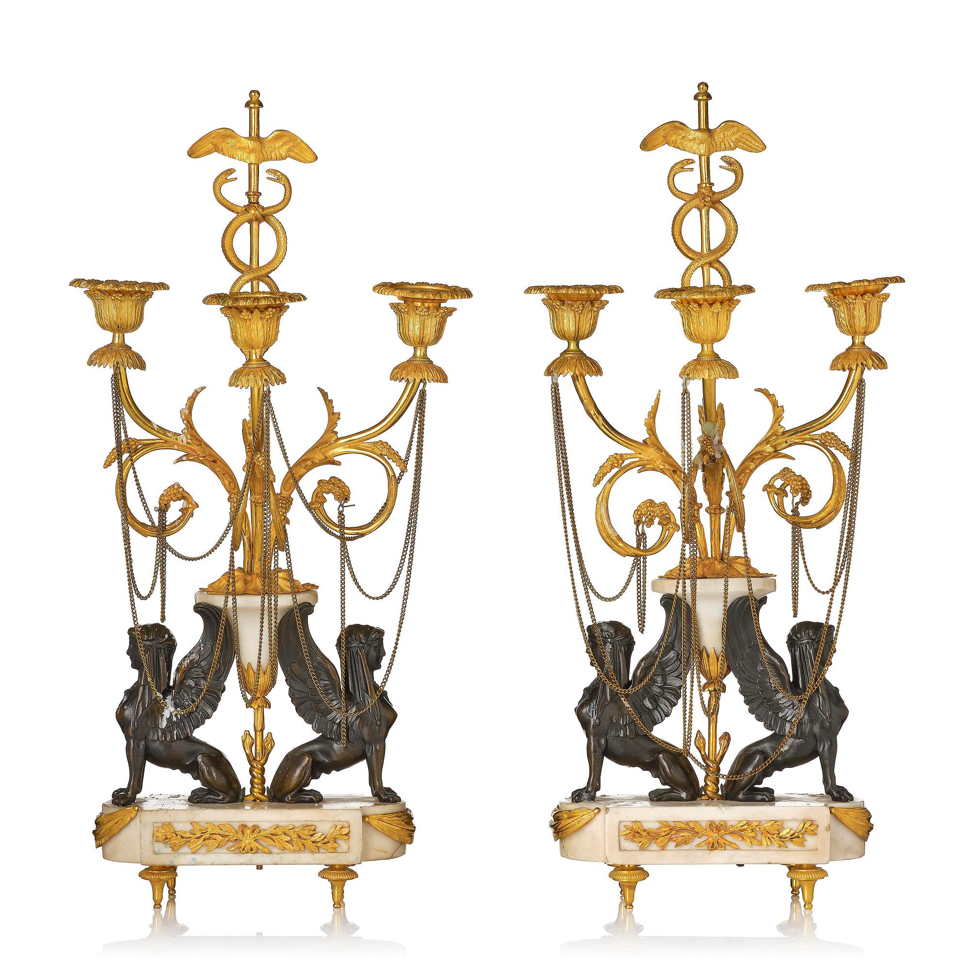 A pair of Louis XVI three lights Candelabra, Parisian works, in the manner of François Rémond, late 18th century.