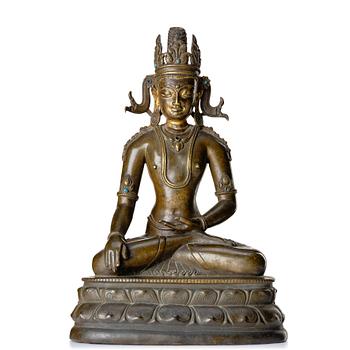 850. A bronze figure of a crowned buddha, Tibet, 14th Century.