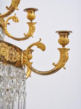 An ormolu and cut glass sixteen-branch Empire chandelier, Paris, early 19th century.