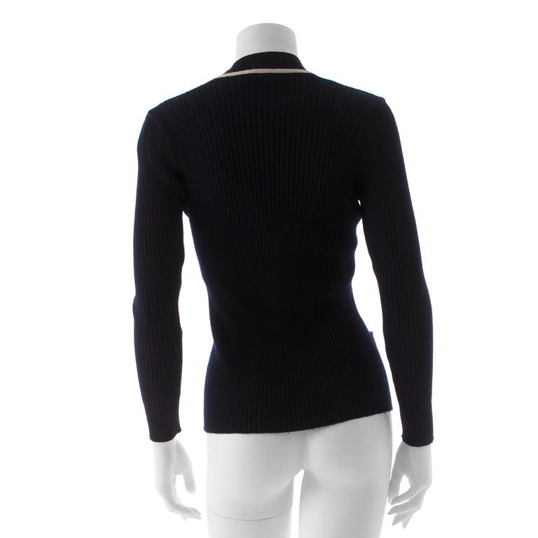CÉLINE, a navy blue cardigan.