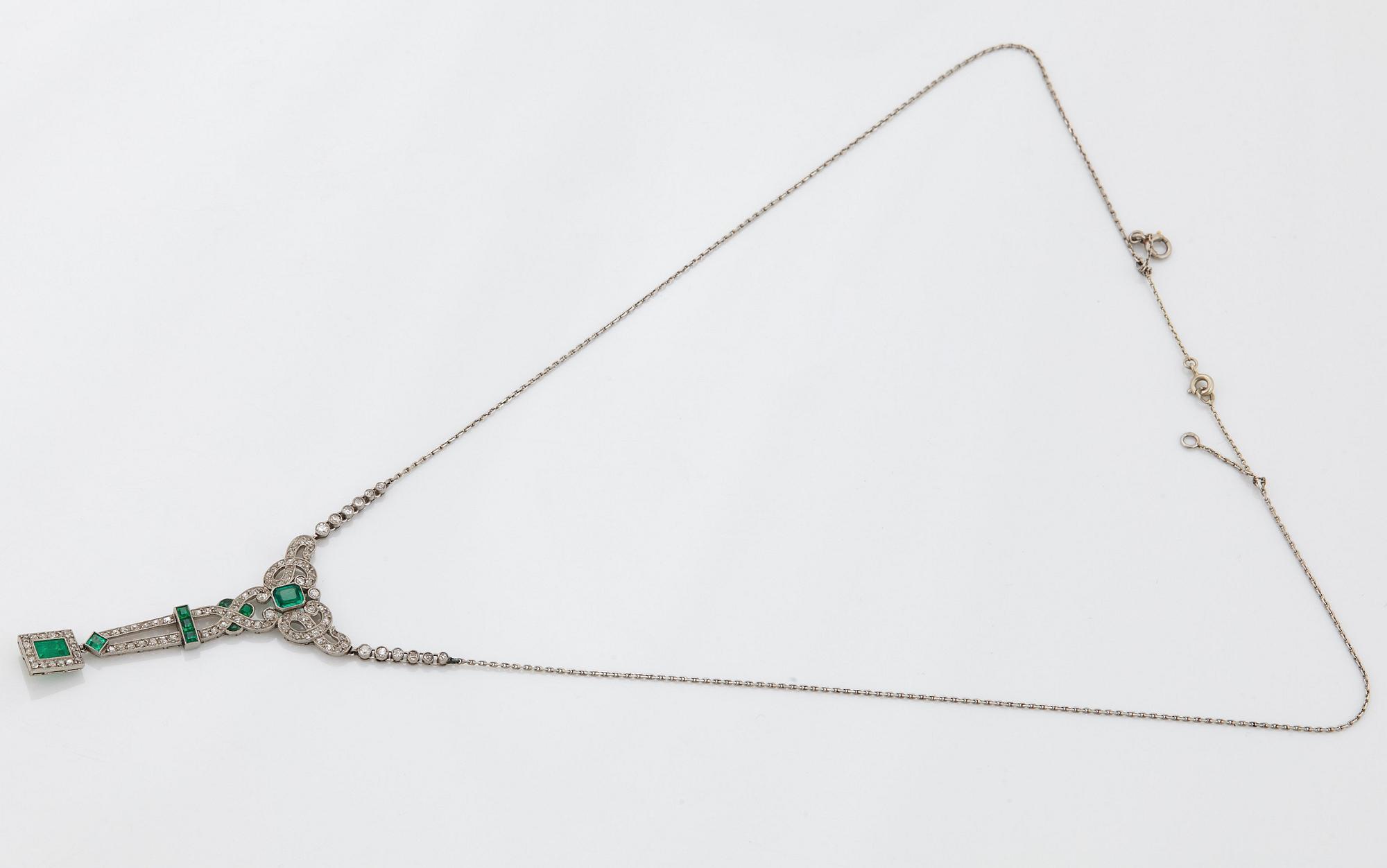 A platinum necklace set with faceted emeralds and old- and eight-cut diamonds.