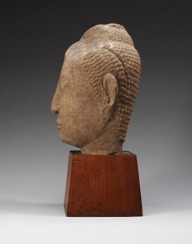A large Lopbury type (later style) sandstone head of a Buddha, 17/18th Century.