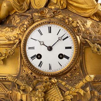 A table clock and a pair of candelabras, Louis XVI-style, France, beginning of the 20th century.