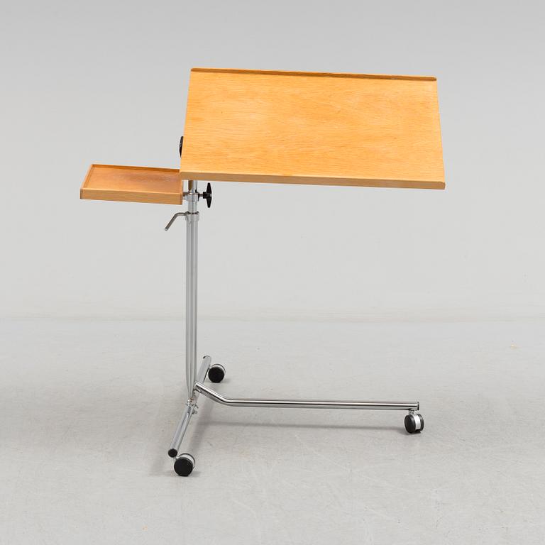 A teak reading table, second half of the 20th Century.