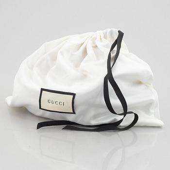 Gucci, a waist bag.