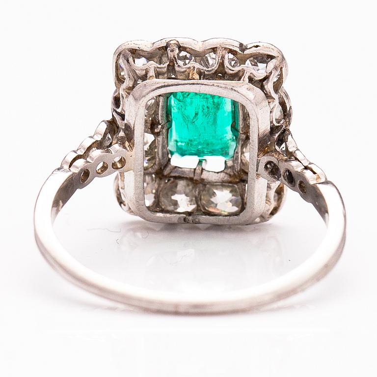 A platinum ring with an emerald ca 0.71 ct and old cut diamonds ca 1.66 ct in total.