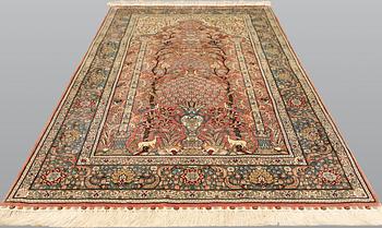 An oriental silk rug, approx. 155 x 93 cm.