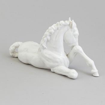 A white glazed porcelain figure of a reclining foal, Meissen, 1950's.