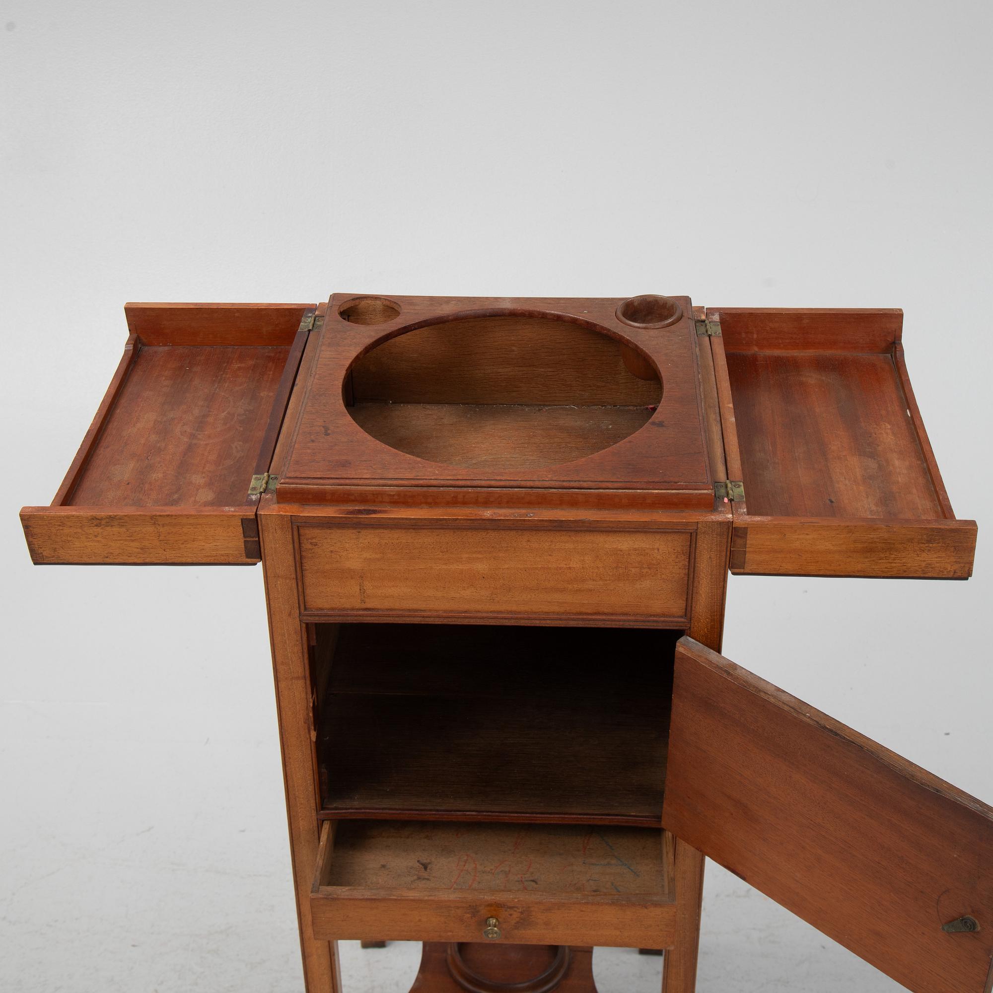 A mahogany shaving stand, 19th Century.