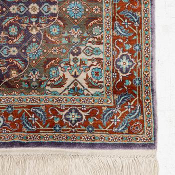 An oriental silk rug, c. 124 x 62 cm.