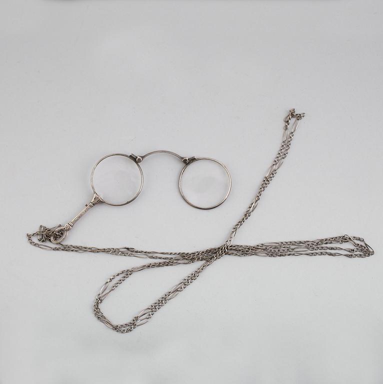 LORGNETTE MED KEDJA, silver, omkring år 1900.