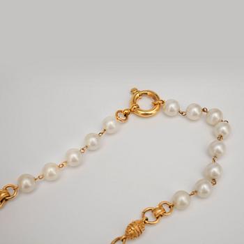 CHANEL, a necklace with decorative white pearls and gold colored embellishment.