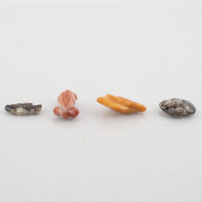 A group of eight Chinese stone charms / pendants, 20th century.