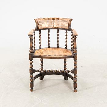 A rattan and wooden barocque-style chair from the first half of the 20th century.