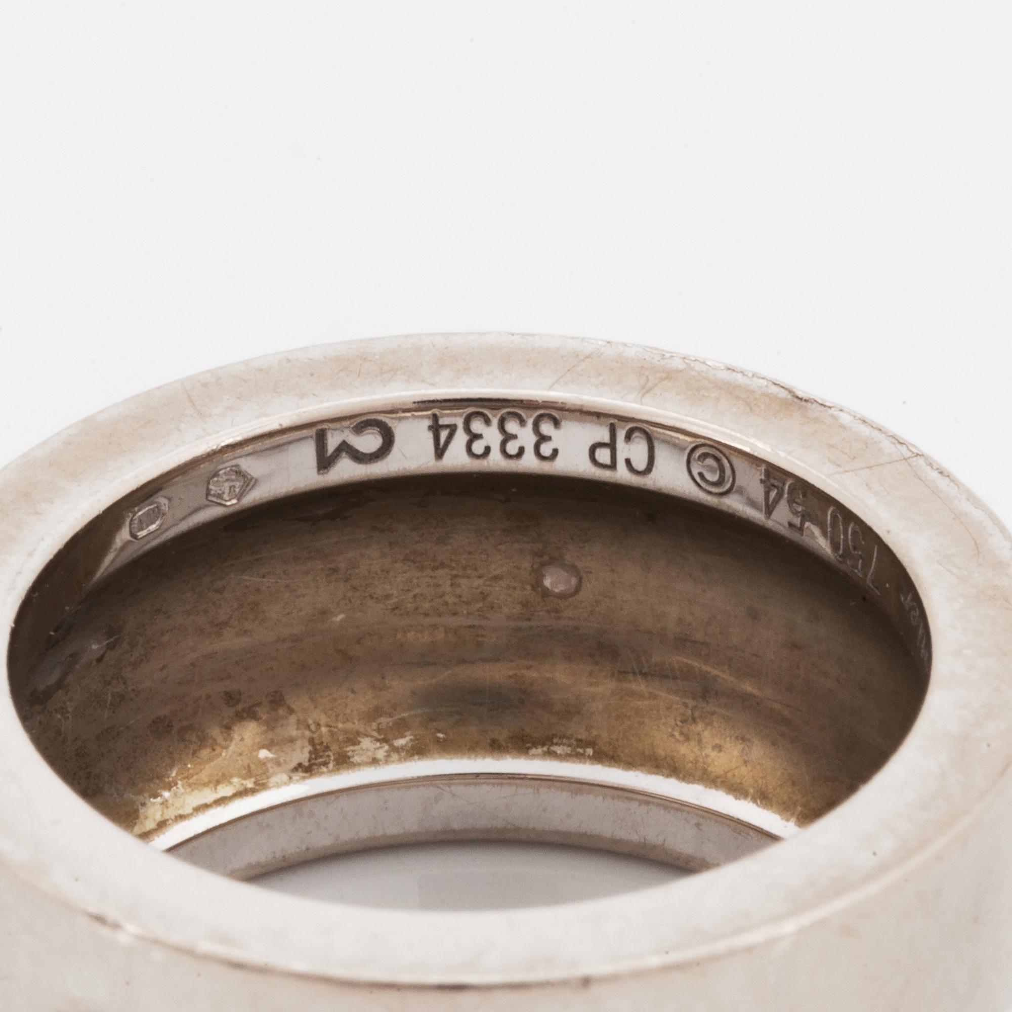 A Cartier 18K white gold ring set with a round brilliant-cut diamond.
