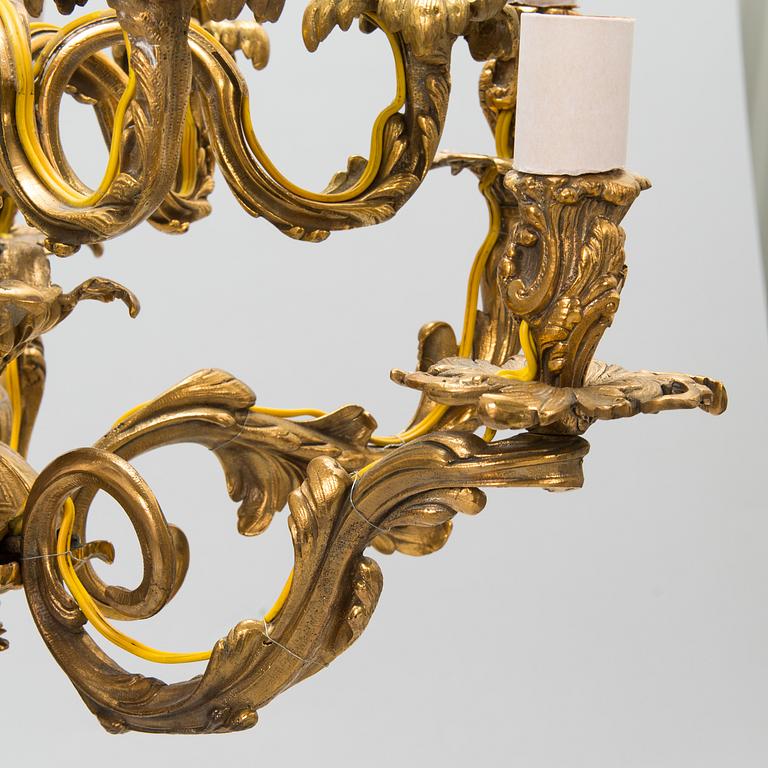 A late 19th-century 12-arm bronze chandelier.