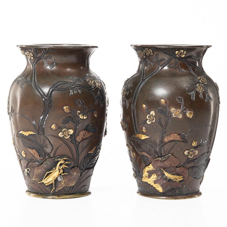 A pair of Japanese metal vases, Meiji (1868-1912).