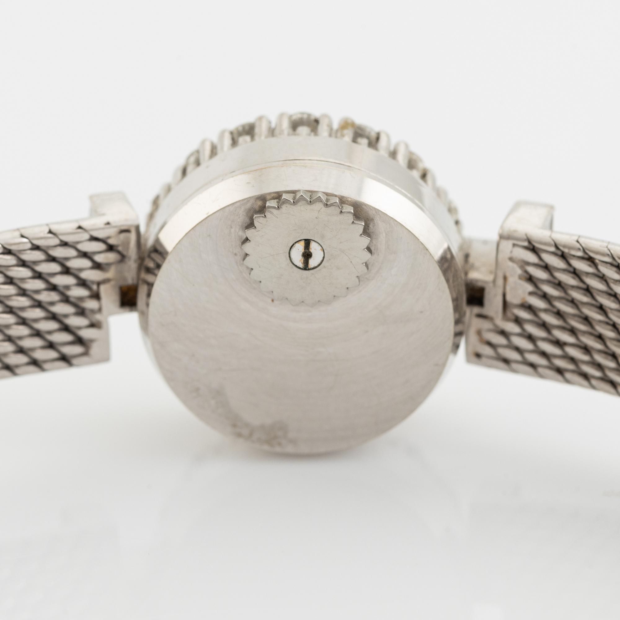 Corum, damarmbandsur i vitguld med baguette- och briljantslipade diamanter.