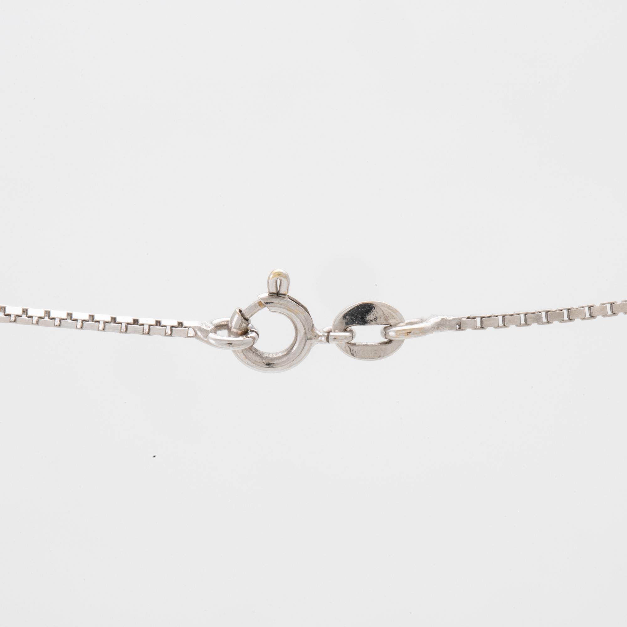 An 18K white gold necklace set with a drop-shaped cultured pearl and round brilliant-cut diamonds.