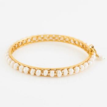 Arm ring, 18K gold with pearls.