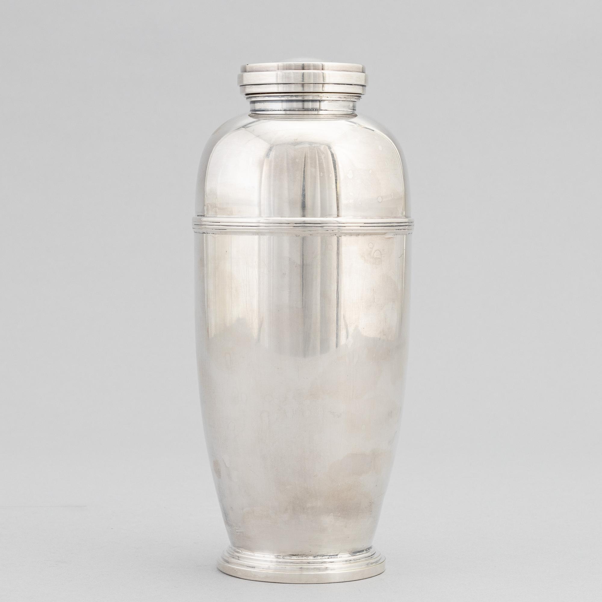A silver plated shaker, C.G. Hallberg and a set of twelwe cocktail glasses, GAB, second half of the 20th Century.