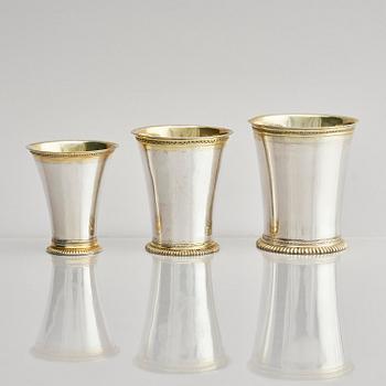 Three Swedish 18th century parcel-gilt silver beakers and a case of birch, different maker's.