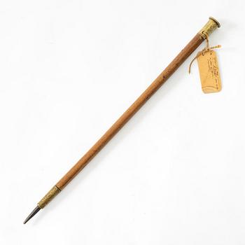 A Swedish brass and wood cane, dated 1740 and 1756.