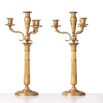 A pair of Empire early 19th century gilt bronze four-light candelabra.