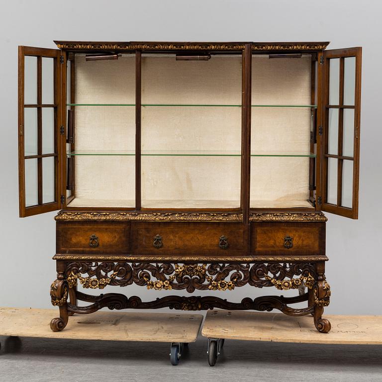 a baroque-style vitrine cabinet from the first half of the 20th century.