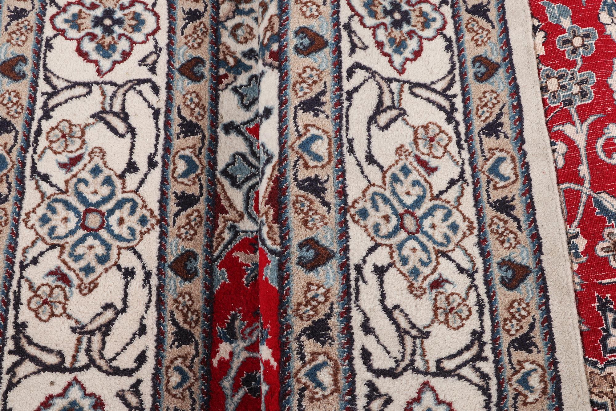 A Nain carpet, part silk, 9 laa, c. 303 x 198 cm.