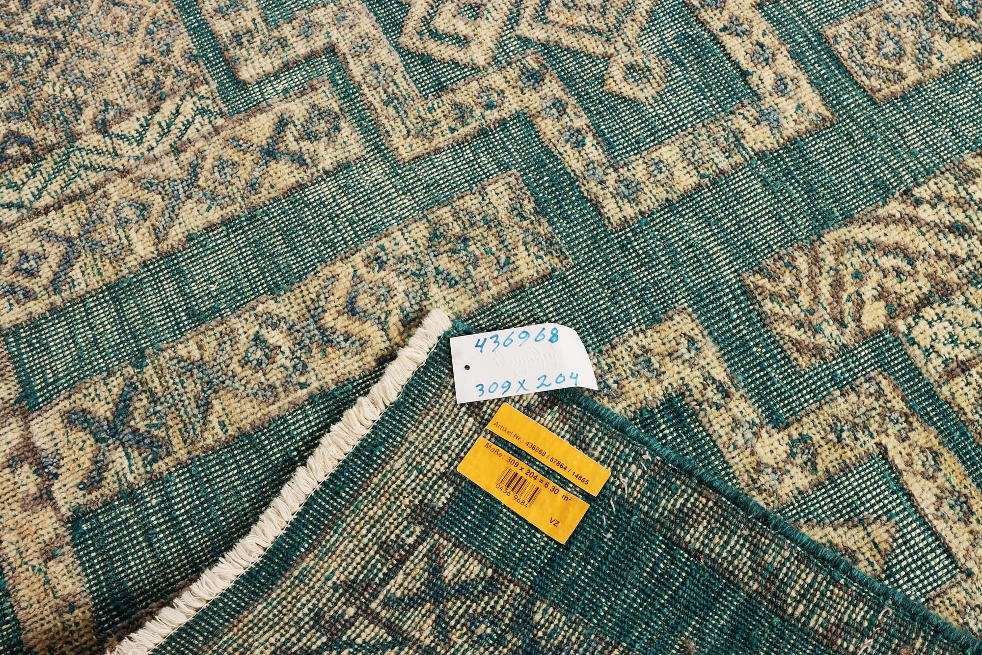 An oriental carpet with relief pattern, c. 309 x 204 cm.