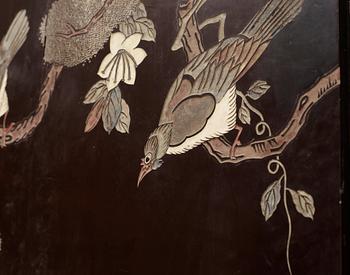 A coromandel black-lacquer four panel screen, Qing Dynasty (1644-1912).