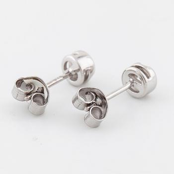 A pair of brilliant cut diamond earrings.