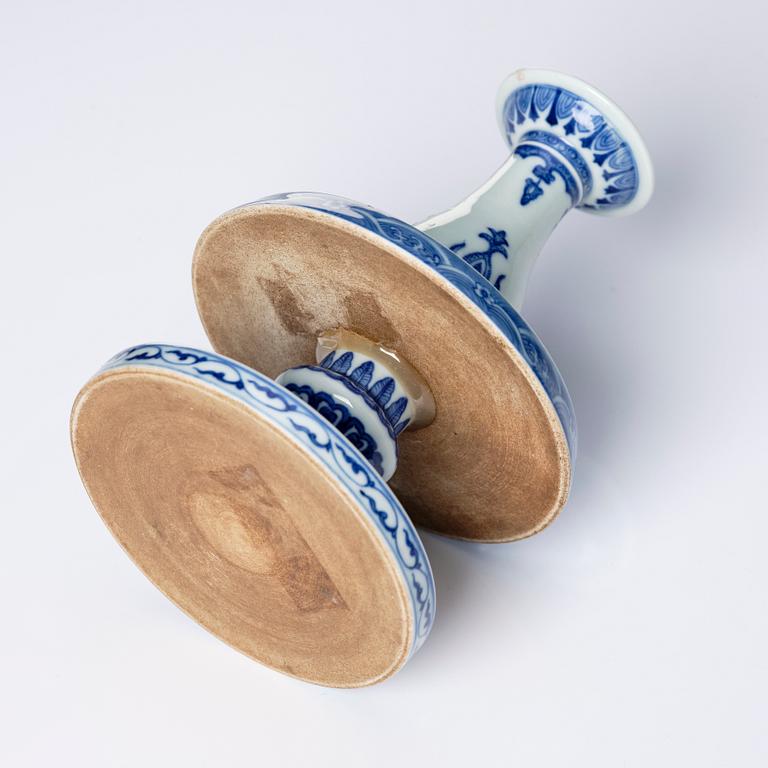 A pair of blue and white pricket candle sticks, with a poem, Qing dynasty with a Qianlong mark and of the period.