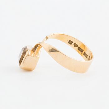 A ring set with an octagonal, step-cut citrine.