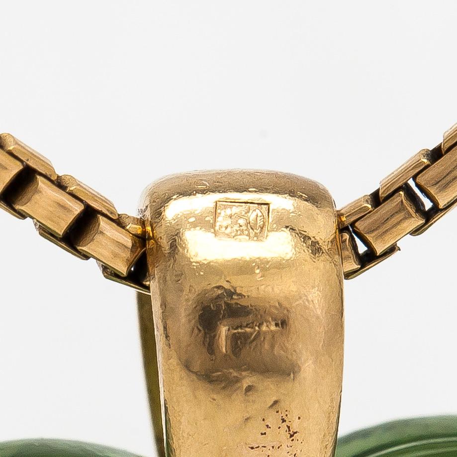 A Lalique heart pendant with an 18K gold chain.