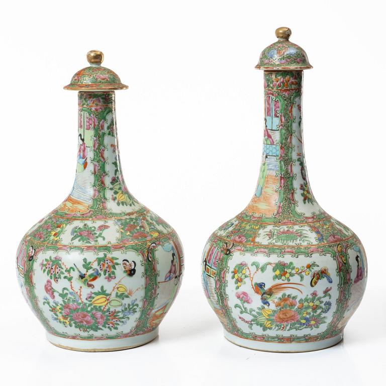 Two famille rose 'Canton' vases with covers, Qing dynasty, 19th century.