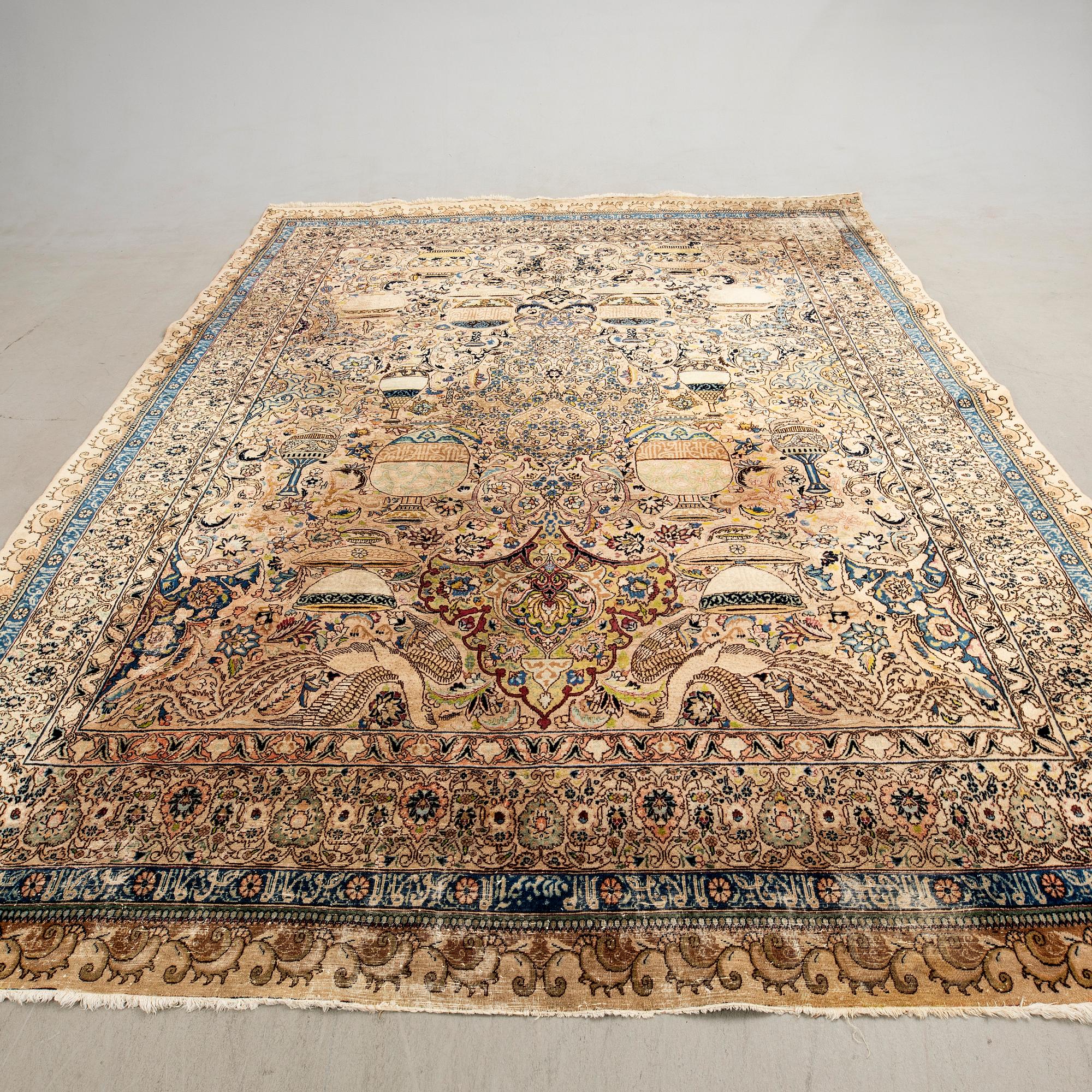An antique Tabriz carpet, North West Persia, signed Akhondzadeh, c. 394 x 295 cm.