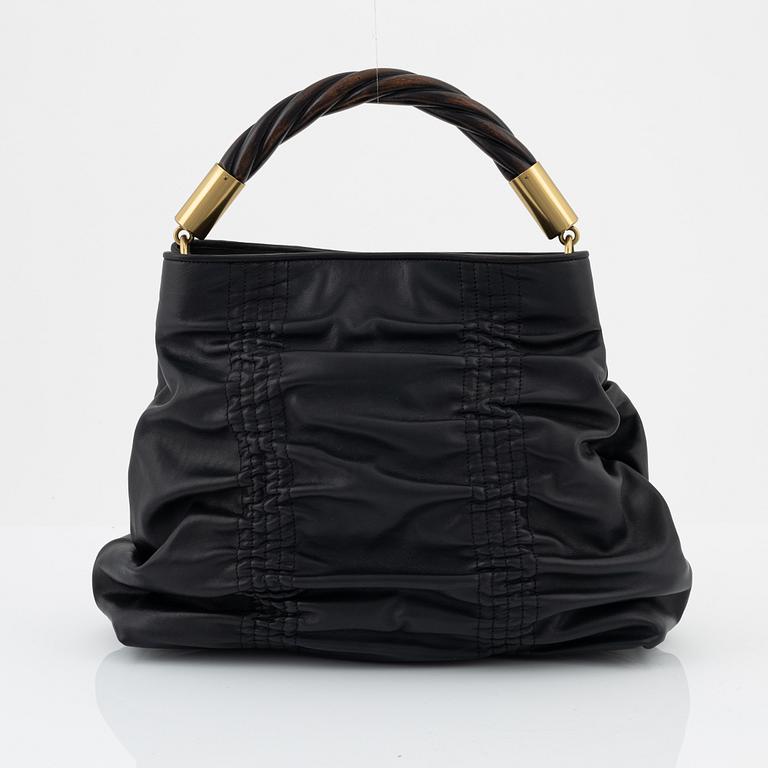 Gucci, a black leather handbag.