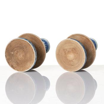 A pair of blue and white pricket candle sticks, with a poem, Qing dynasty with a Qianlong mark and of the period.