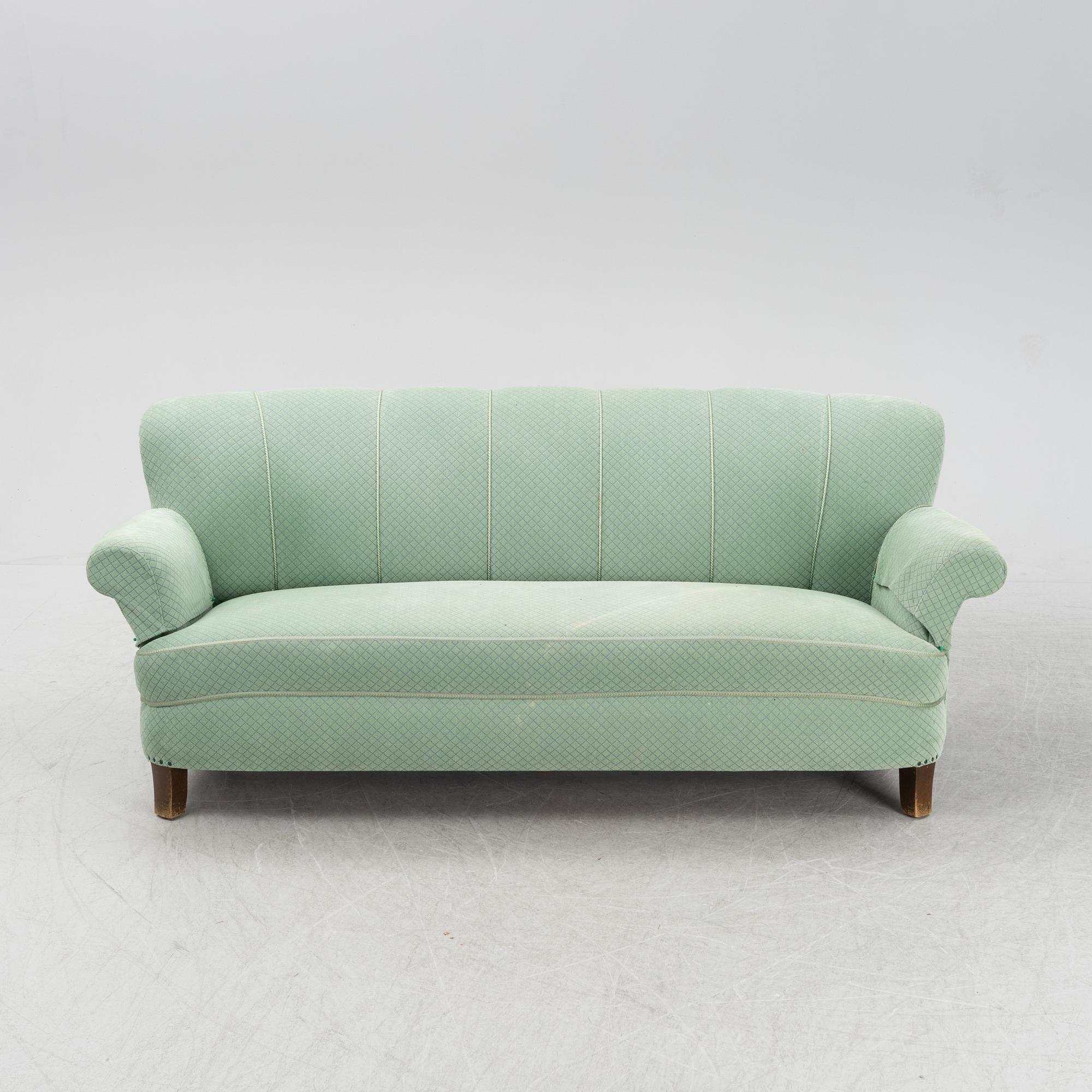 A mid 20th Century sofa and easy chair.