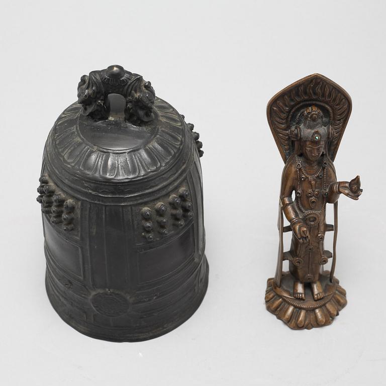 A Chinese temple bell and a figure of a deity, 20th Century.