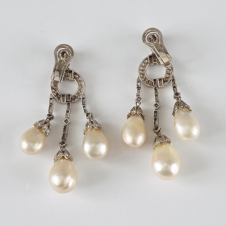 A pair of natural drop-shaped saltwater pearl and diamond Girandole earrings.