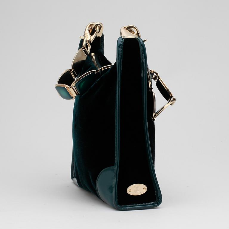 CÉLINE, a green velvet handbag.