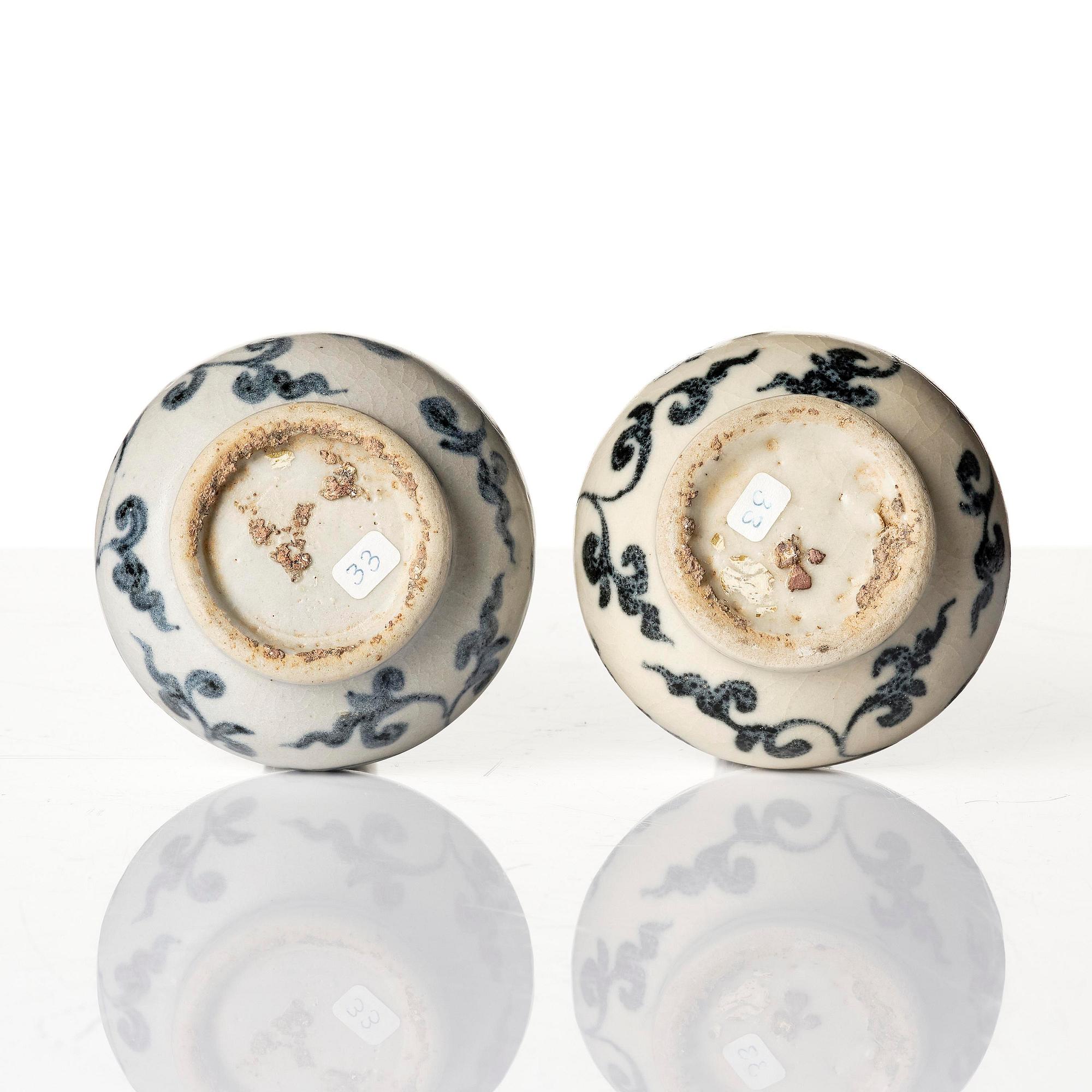 A pair of blue and white lotus vases/water sprinklers, Ming dynasty (1368-1644).