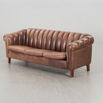 A leather sofa and armchair, 20th century latter part.