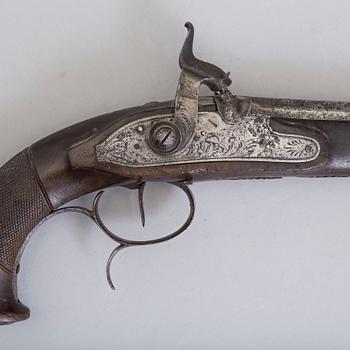 A 19th century percussion pistol.