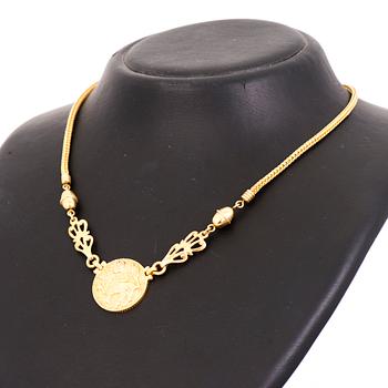 KAULAKORU, "Aurinkoleijona", 18K kultaa. Kalevala Koru 1998.