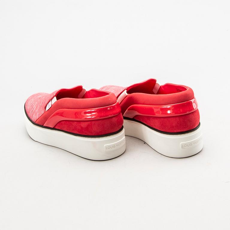 A pair of Louis Vuitton sneakers.