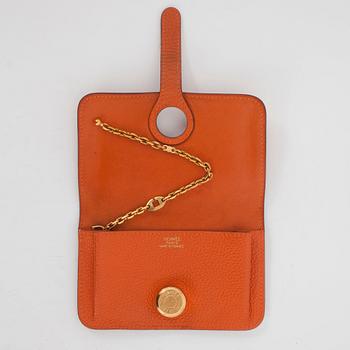 HERMÈS, a orange leather key holder.